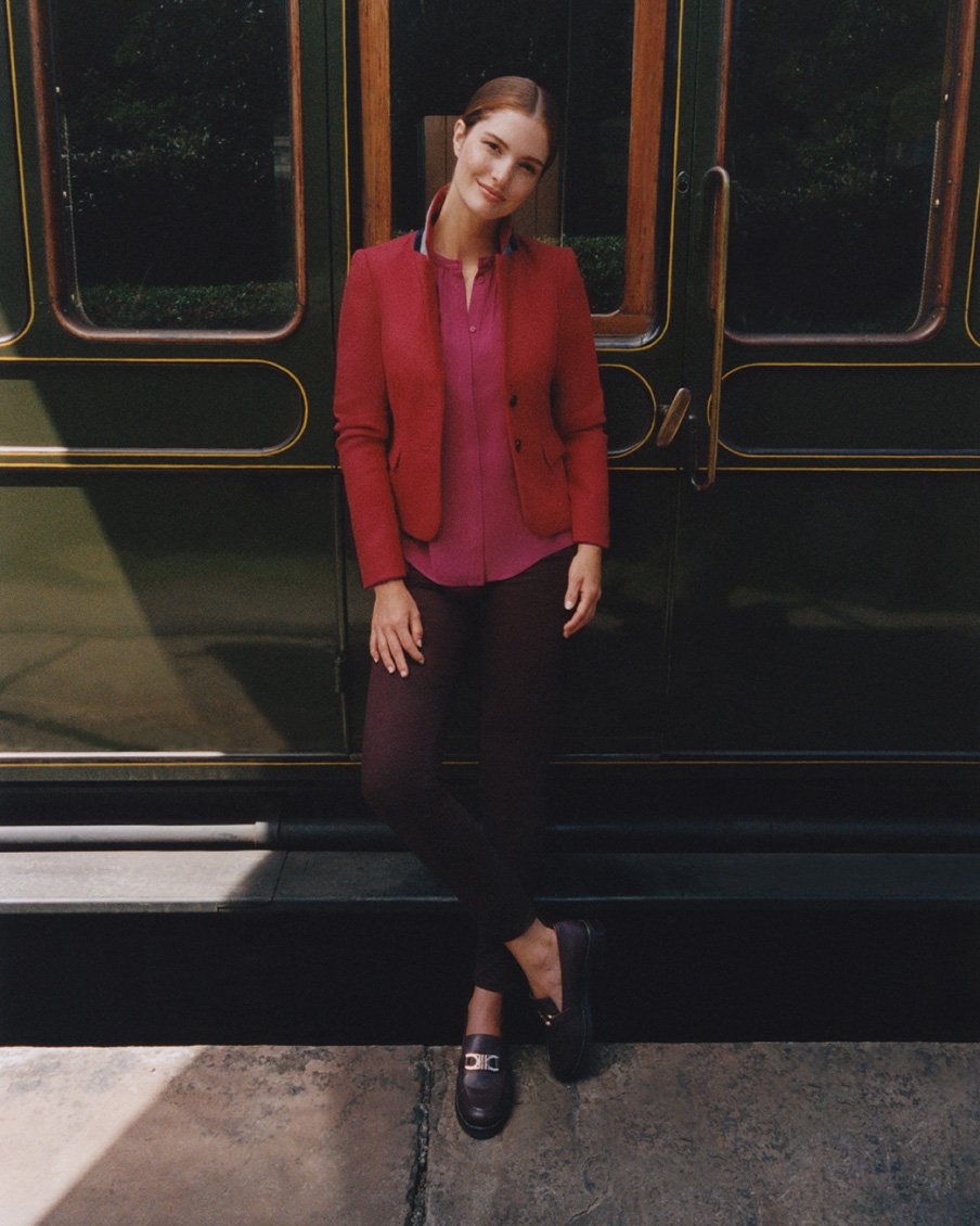 Hobbs model stands next to a heritage train wearing a tweed jacket.