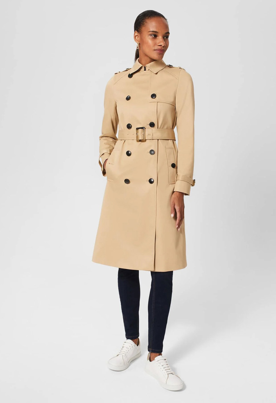 Model wears a Hobbs classic trench coat in tan.