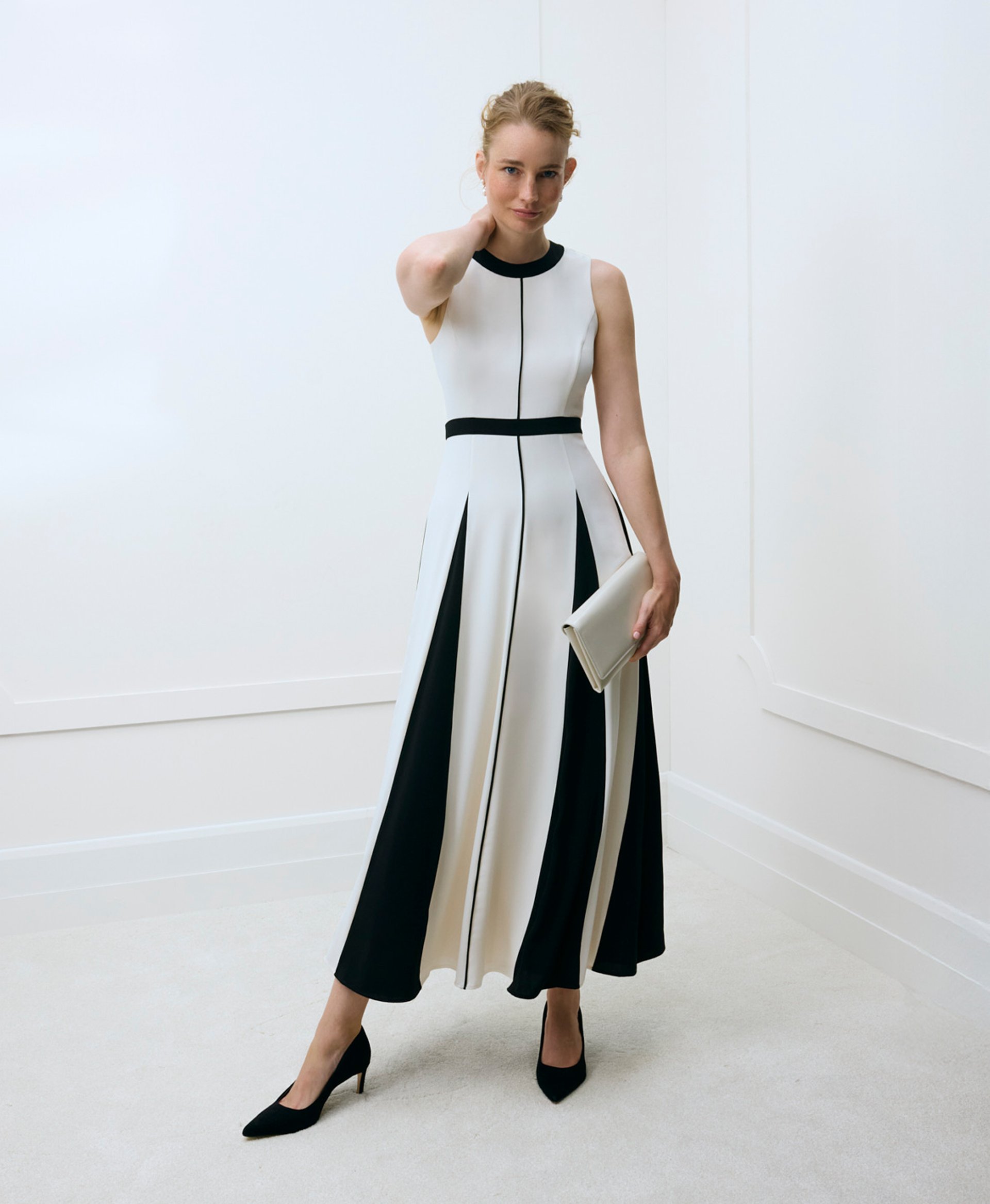 A woman wearing a colourblock Hobbs occasion dress.