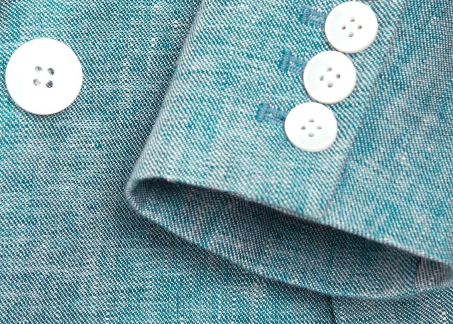 Close-up image of green linen suit jacket.