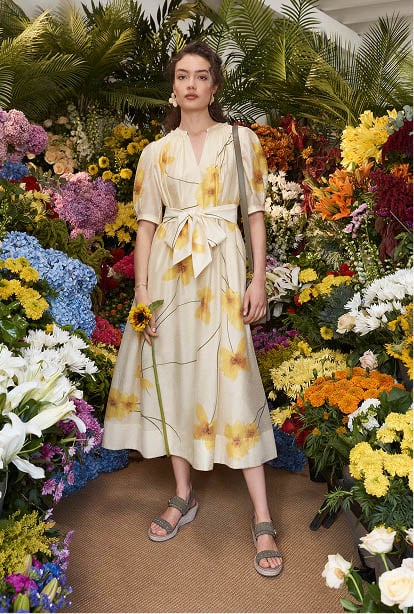 A woman wearing a floral print Hobbs dress.