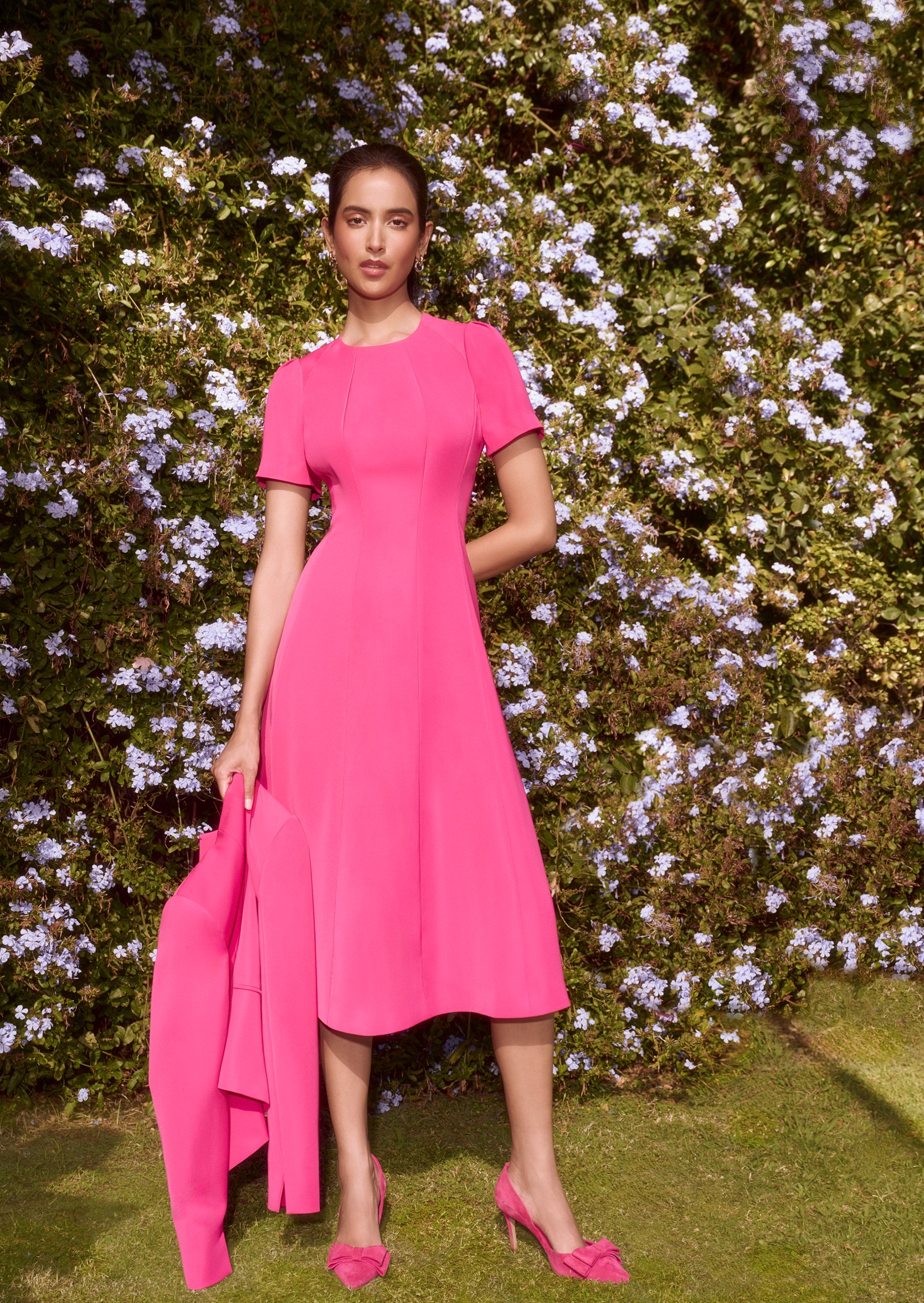 An image of a model wearing a coordinating pink occasion outfit from Hobbs.