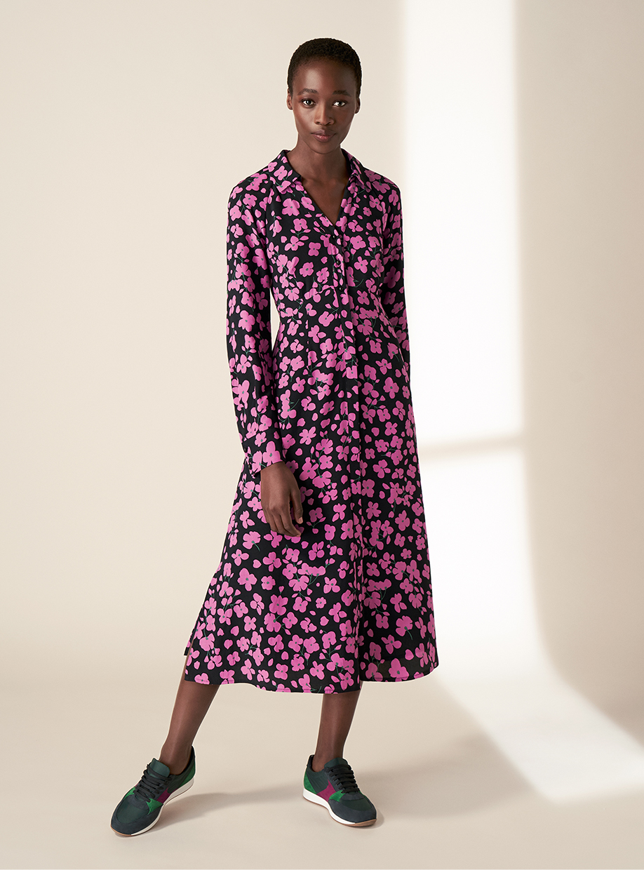 Model wearing the Hobbs Lulu navy and pink floral print shirt dress with trainers.