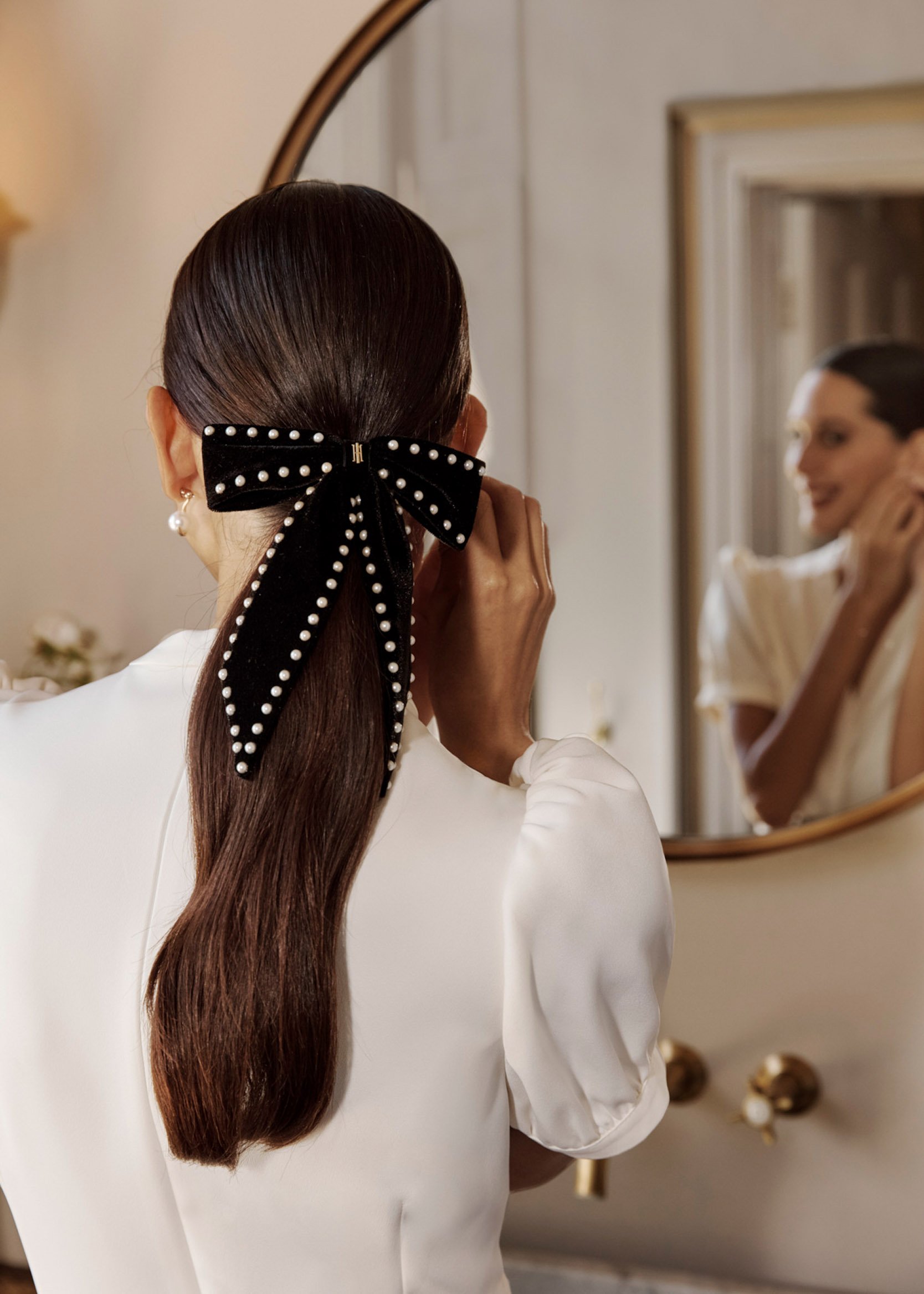 A woman showcasing Hobbs’ occasion accessories.