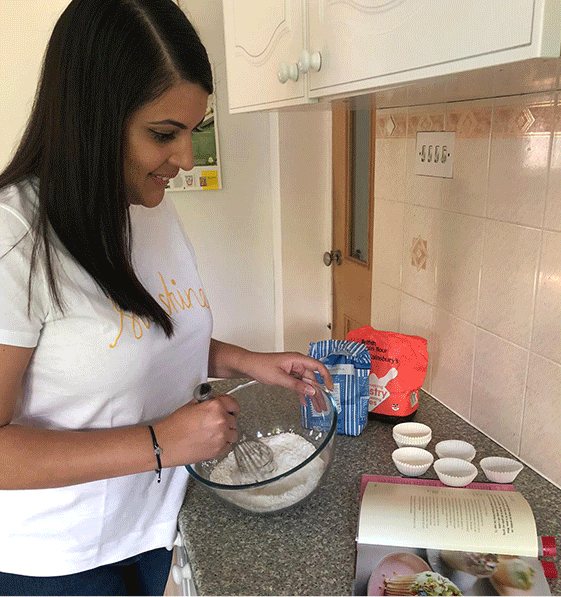 Priya bakes at home wearing the Hobbs sunshine t-shirt and gia sculpting jean