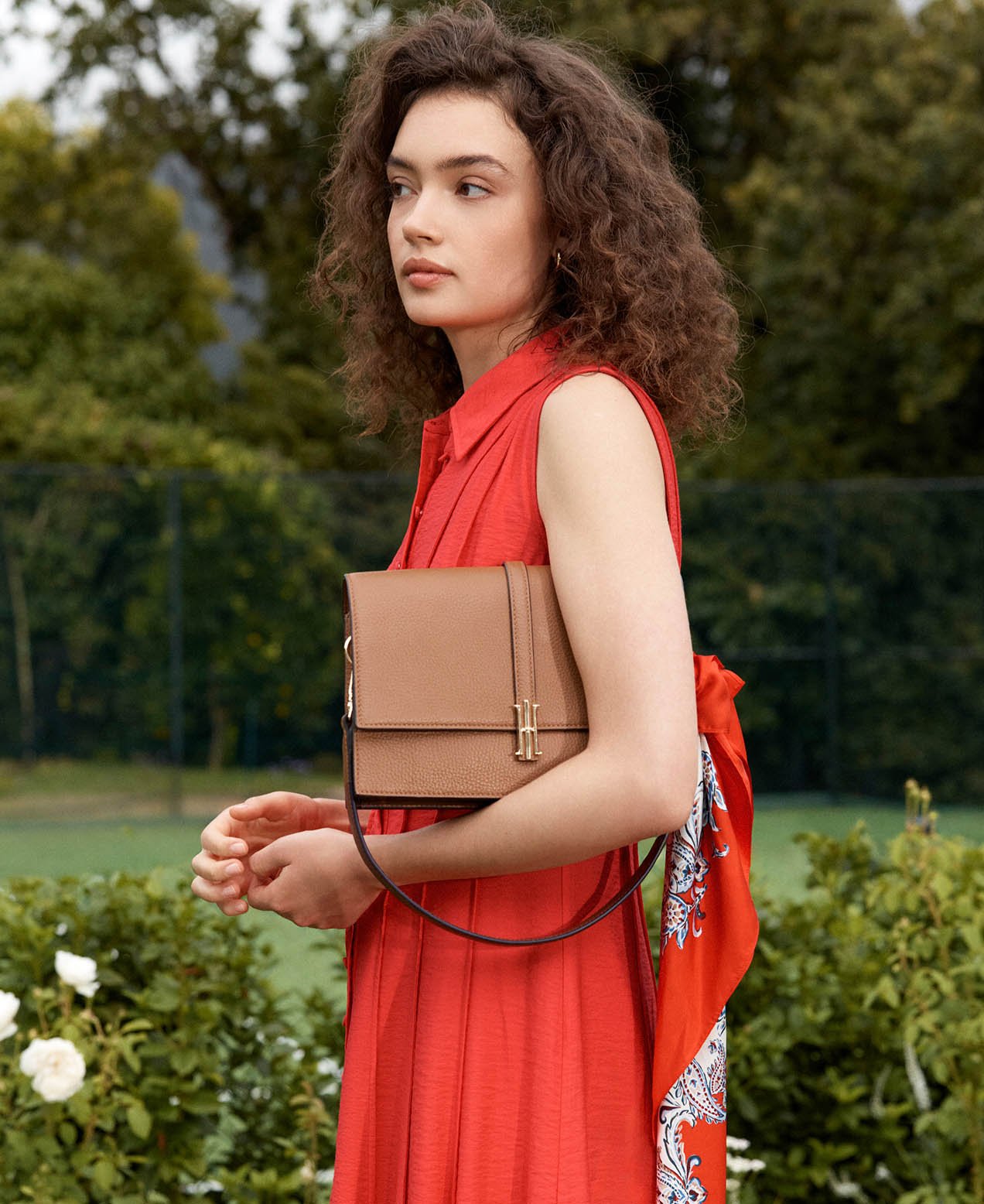 A woman wearing a red Hobbs shirt dress.